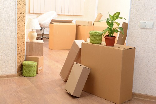 Packed moving boxes and furniture prepared for collection in Bermondsey