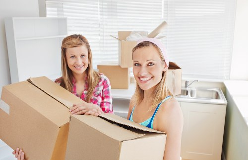 Careful unpacking of household items in a Bermondsey apartment